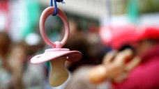 Toddlers are less likely to have asthma and itchy rashes if their parents cleaned their pacifiers by sucking on them when the kids were infants, a small new study suggests